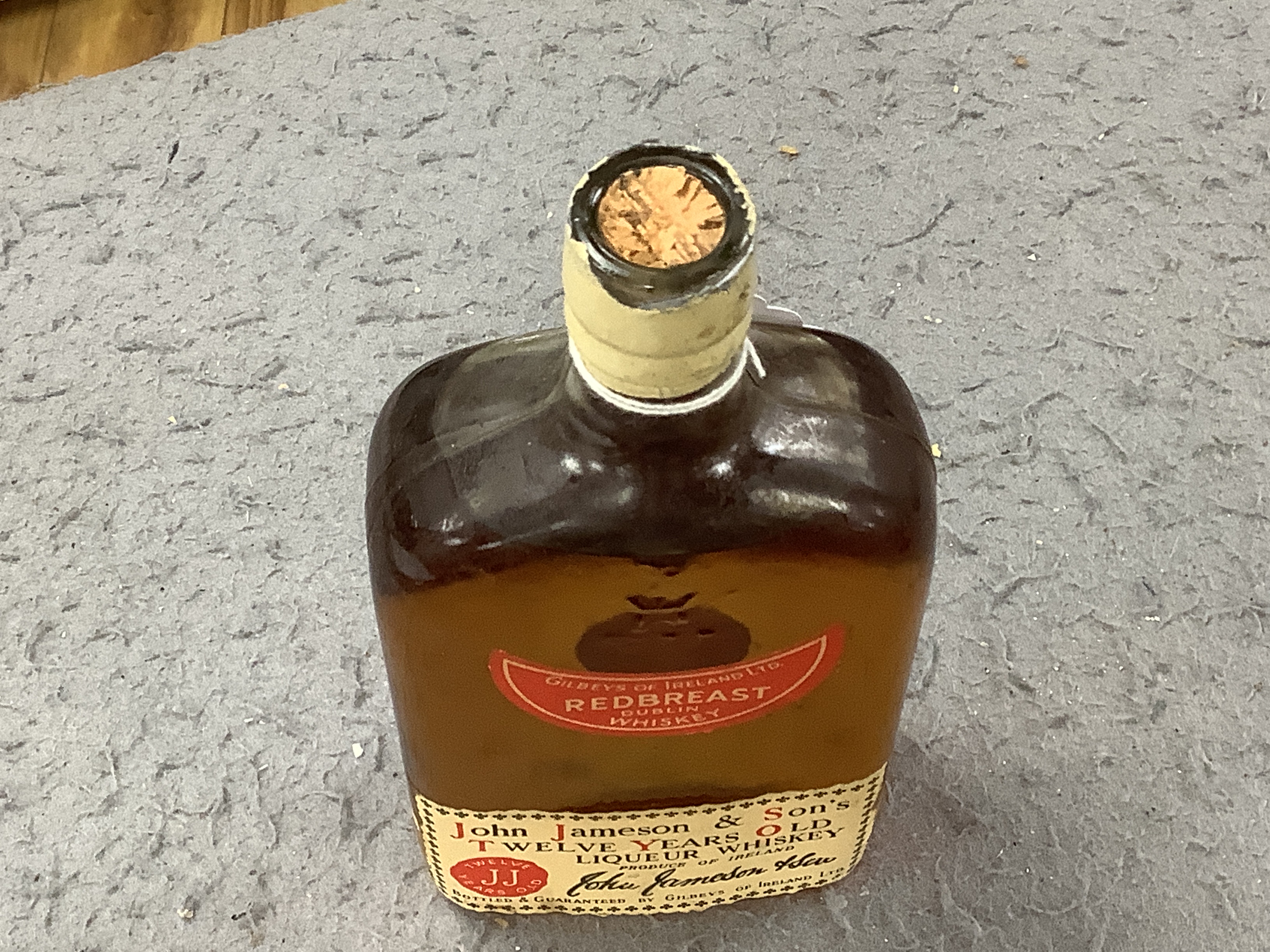 Two bottles of whisky and a John Jameson & Sons bottle